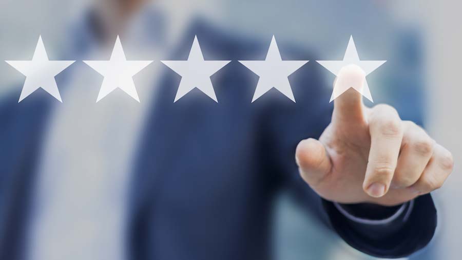 Person wearing suit selecting five stars for a review